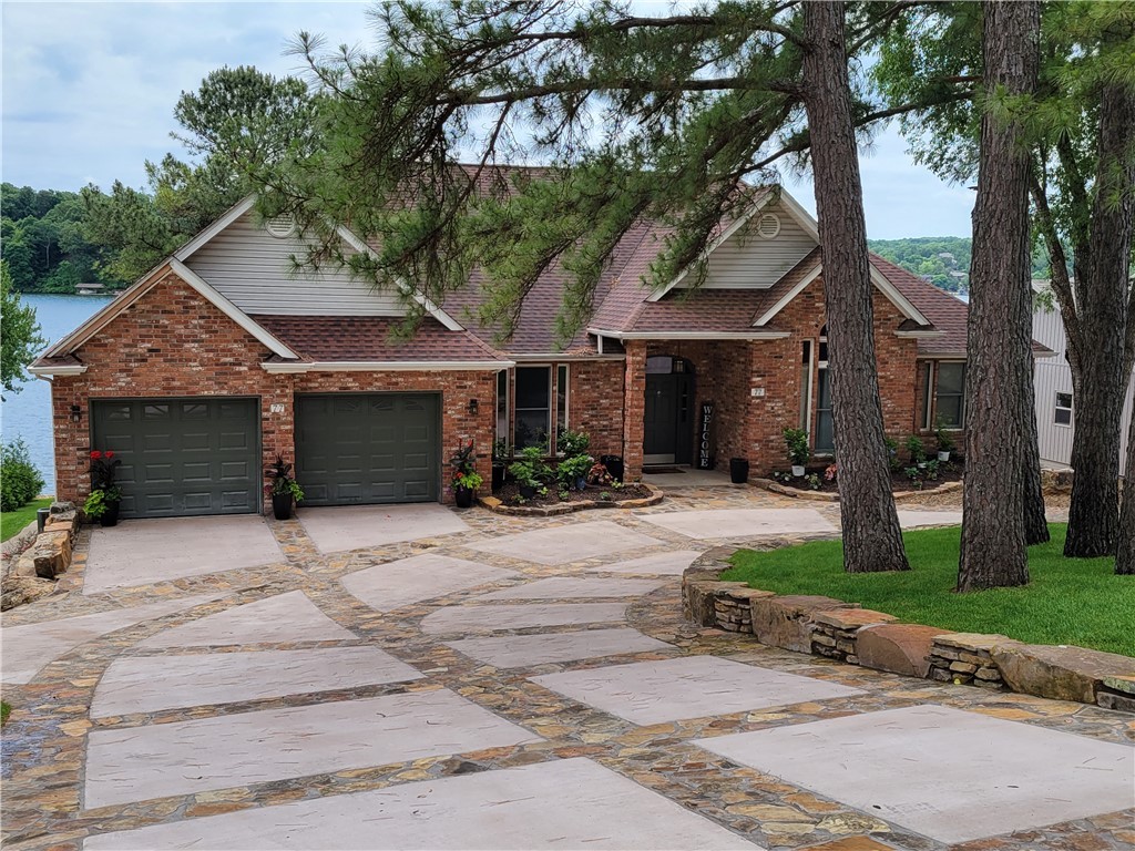 Make plans to view this gorgeous"must-see", Perfectly located Lakefront home. From the generous light-filled windows, there are beautiful wide water views. You can see the paved walkway for easy access to the water's edge, with a concrete boat dock, elect. lift, and a sun deck. You will note upon entering the custom-crafted driveway, that sets the tone of this stunning home that boasts 4 full bedrooms and 3.5 baths (the master bath is amazing with its copper tub, rock walls, double granite vanity, and glass shower) there is also a study, sunroom, an amazing kitchen, and formal dining room on the upper level. The lower level adds a full kitchen, eat-in dining area, and great room with 2 more bedrooms and two full baths. This level also has a major storage room and a concrete safe room. The home is all freshly painted has new flooring, and new light fixtures, and exudes lodge appeal. Currently being used as a vacation rental. You can discuss the possibilities of purchasing fully furnished with the owner upon request.
