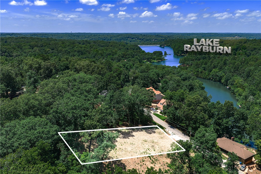 Build your dream home on this beautiful 0.34-acre lot in Bella Vista's Lambeth Subdivision, offering a peaceful wooded setting with a gentle slope and stunning views of Lake Rayburn. As a Bella Vista property, you'll enjoy access to the community's incredible POA amenities, including multiple lakes, golf courses, swimming pools, tennis courts, and an extensive trail system perfect for biking, mountain biking, and walking—many of which are right in your backyard. With public water and paved roads already at the street, this cleared lot is build-ready. Located within Bentonville School District and just minutes from Downtown Bentonville and the Walmart Home Office, this is a great opportunity to own land in one of Northwest Arkansas's most desirable, amenity-rich communities. Come see why Bella Vista living is so highly sought after!