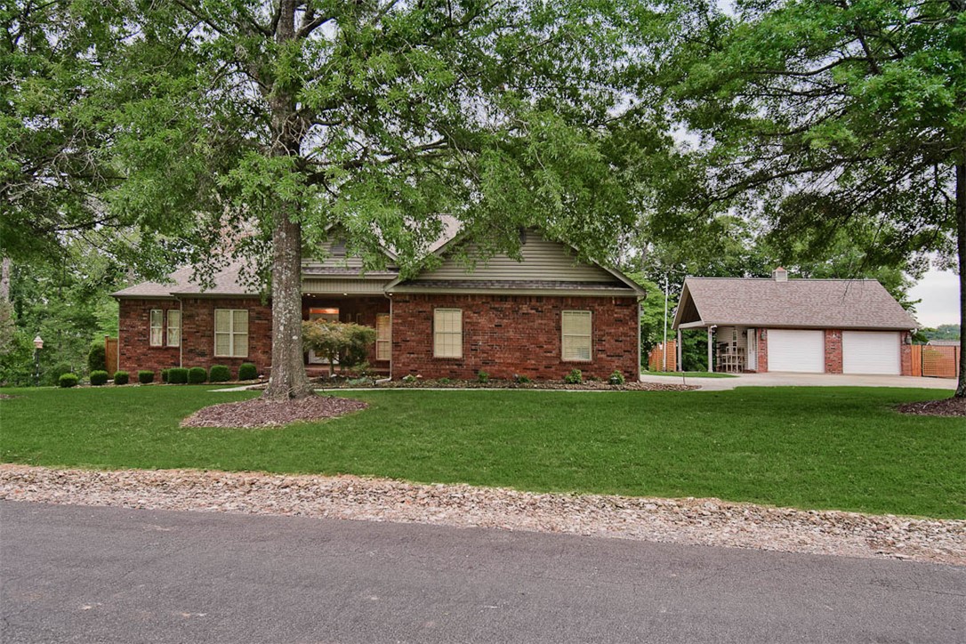 This Bella Vista gem sits on a private, landscaped 0.68-acre lot with seasonal views near Lakepoint Marina. Inside, a bright, open layout showcases beautiful wood floors, a private office, formal dining, and a cozy fireplace with custom built-ins. The gourmet kitchen boasts a raised bar, granite counters, a beverage fridge, & endless cabinetry, while the smart split floor plan offers spacious bedrooms with private en-suite baths. The primary suite includes an elegant tray ceiling, a huge walk-in closet, and a whirlpool tub. The outdoor oasis features an oversized 2-car side-load garage, and a detached 2-car workshop with an extended covered area, & a tranquil backyard retreat with a gazebo, covered patio, and a cascading koi pond.  Best of all, you are just minutes from premier golf at Highlands and Scotsdale, plus world-class trail networks like Branchwood and Little Sugar. Whether you want a flat, paved cruise below the dam or rugged dirt singletrack weaving through the bluffs, the perfect ride starts right here.