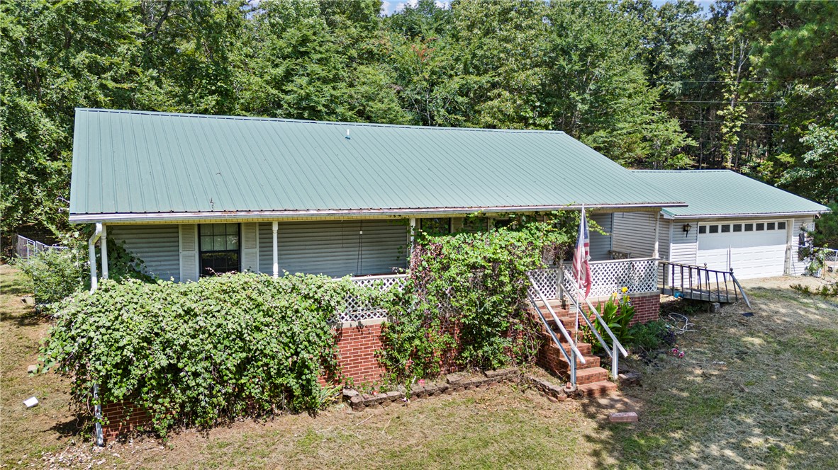 Enjoy peaceful country living in this 3-bedroom, 2-bath home situated on 2.80 acres just minutes from Russellville and convenient interstate access. Built in 1995, this home offers approximately 1,260 heated sq. ft., an eat-in kitchen with solid surface countertops, and an attached two-car garage. With plenty of outdoor space and room to make it your own, this property offers the perfect blend of privacy and convenience.