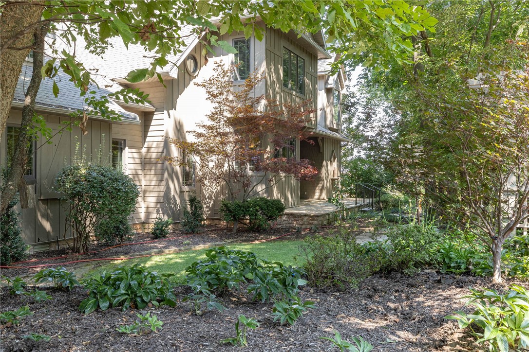 Exquisite custom built contemporary craftsman home on Mt. Sequoyah. This 1-owner cedar sided home, was built with the utmost attention to detail. The living room with a cathedral ceiling is trimmed with cherry, gas fireplace and plantation shutters. A huge butcher block island anchors the kitchen, with granite, gas range, cherry cabinets and double oven as a true chef's workspace. The primary suite features a cathedral ceiling & beams & private screened-in porch for peaceful tea time and a book. The den and living room have gas fireplaces. Well trimmed bathroom with dual vanity, makeup station, soaker tub and large closets. Upstairs, you will find two bedrooms with vaulted ceilings, beams and a private balcony. Downstairs has a flex room (no window) with a private bathroom. Custom surround sound throughout. Stunning landscaping with tree canopy, native stone work and an incredible water feature. Irrigation on separate meter. Large front porch and deck off back. Tandem 3-car garage/workspace. Whole house generator.