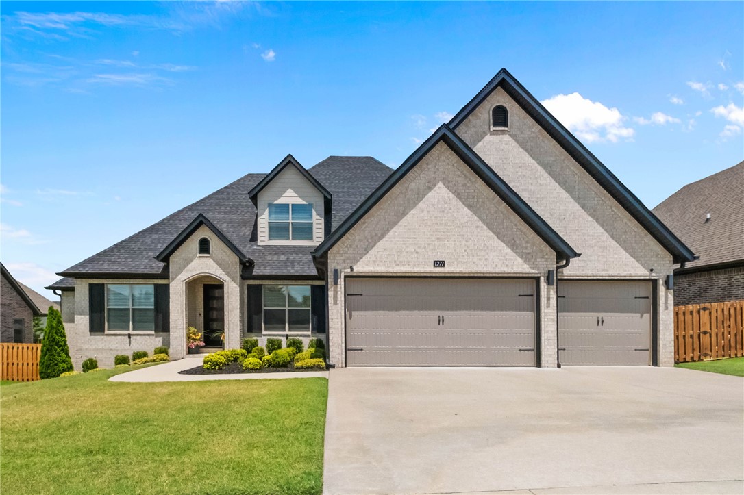 Welcome to this stunning home in Bentonville’s highly desirable Creekside neighborhood! Impeccably crafted with no detail spared, this residence boasts beautiful hardwood floors throughout. Functional split floor plan maximizes privacy, highlighted by a luxurious primary suite featuring a tray ceiling, and a massive walk-in closet with custom built-ins. At the heart of the home, the gourmet kitchen shines with custom cabinetry extending to the ceiling, a expansive contrasting center island, tile backsplash, and stainless steel appliances. The light-filled living room anchors the space with custom built-in shelves flanking a cozy gas fireplace. Step outside to a spacious covered back porch designed for year-round entertaining, overlooking a fully fenced yard complete with a clean, low-maintenance turf space perfect for play. Accentuated by a 3-car garage this turn-key property offers modern elegance at every turn.