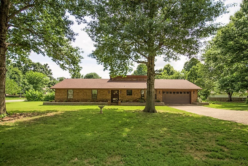 Come see this great 3bed/2bath, older home on a large lot in east Fayetteville. This home has a vaulted ceiling in the living room with a beautiful brick corner fireplace. New roof, HVAC and privacy fence in the last 4 years, just needs a bit of updating. Beautiful flat yard on a corner lot with mature trees and a screened in back patio. There's a community pool.