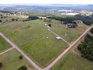 A farm with Glorious views, from this fully fenced 40 acres with a beautiful pond, panoramic views, fenced and cross fenced  improved pasture.  The property has a 1080 square-foot dwelling with a large living room and a huge kitchen with pantry. large master bedroom and two walk-in closets ,the main dwelling has a 720  Square feet garage attached. A 30 x 50 utility building, a 40 x 40 barn,  A mobile home used to reside on the property that was removed but the septic system, electric  and water supply remain.  There's also a set up for a chicken coop and hogs for the farm lovers. Large horse barn too.   This property has so much to offer it won't last long. Call for your showing today.