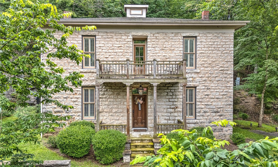 A Eureka Springs Masterpiece! This unique and lovely home has been completely updated in keeping with the grand style. The pristine property is being sold furnished & would make a wonderful primary or second home. Top notch appliances and finishes throughout this open and inviting floor plan include wood flooring, plantation shutters, gorgeous trim and so much more. The expansive back patio is more than you would expect, with plenty of privacy, a stunning wood burning fireplace, built in kitchen and koi pond, for year-round enjoyment! Beautifully landscaped, with ample parking in the driveway and curb appeal galore!! This stunner overlooks Main Street and there is a convenient staircase to get to downtown, right out your front door! Ready to live in and enjoy Downtown Eureka Springs? This is your house!!