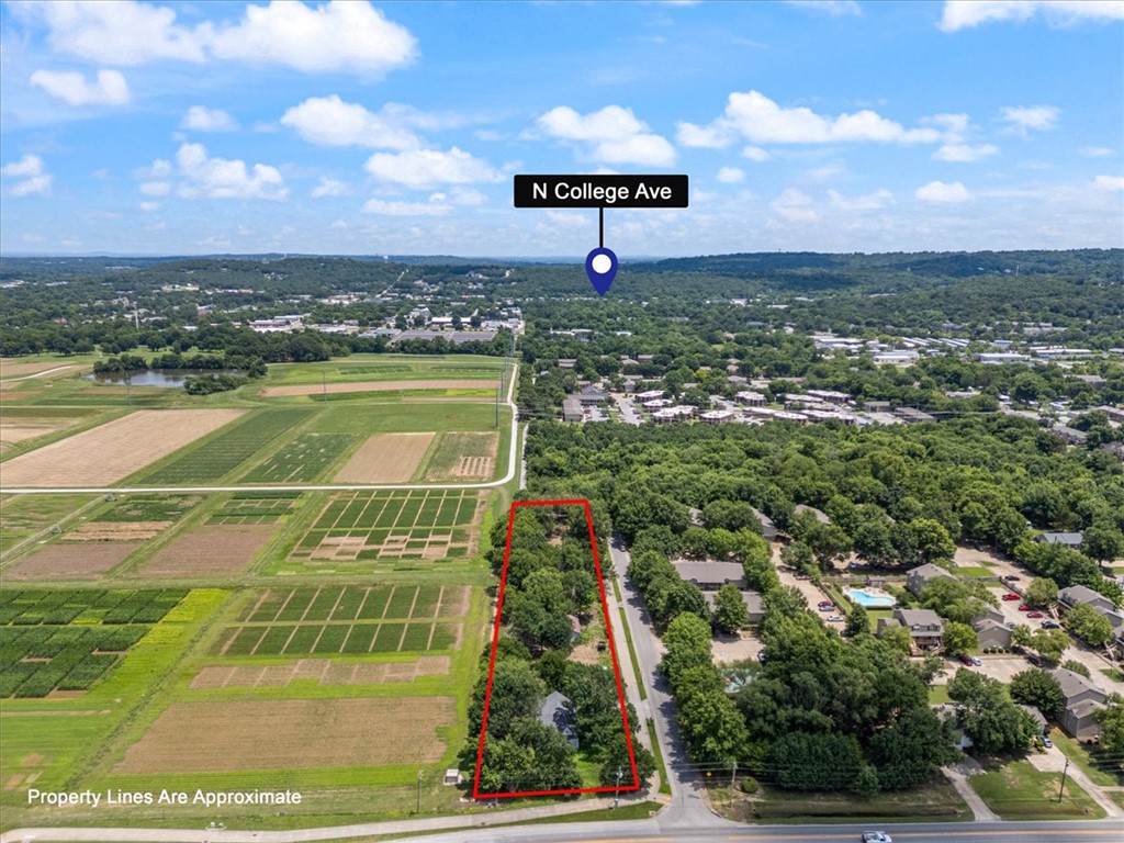 Exceptional Infill Development Opportunity! Rare, RMF-24 zoned property featuring a level site with excellent redevelopment potential in one of the area's most desirable growth corridors. The property includes two income-producing homes and a shop, allowing investors to generate rental income and offset carrying costs during planning, design, and city approval. Previous development concepts demonstrated the potential for up to 37 multifamily units. The layout is ideally suited for townhomes, brownstones, or multifamily development with frontage on both Ernie Jacks and Garland. The south property line borders the Razorback Greenway Trail, while the property backs to the UofA Research Farm which creates a unique setting with lasting open-space views. Opportunities to acquire a large & level income-producing RMF-24 infill tract in this location are exceptionally rare. Ideal for developers seeking their next signature project.