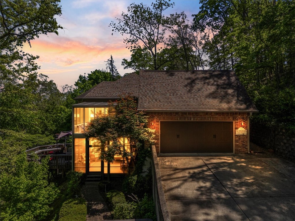 Tucked away on over 5.1 private, wooded acres, this lakefront home offers the perfect blend of luxury, space, & year-round outdoor living. With 3,769 sqft of thoughtfully designed living space, this property features 2 true master suites, 2 living rooms, & 2 sunrooms that capture serene views of the trees & water. The gourmet kitchen is built to impress with Thermador built-in appliances, expansive counter space, & seamless flow into the main living areas—ideal for hosting family, friends, & lakeside gatherings. Retreat to the outdoor haven, complete with a swim spa, oversized deck spaces, & room to explore your own untouched slice of NWA nature. Pull your boat up to the house during the day on those summer afternoons for a quick bite to eat or drink. Whether you’re sipping morning coffee in the sunroom, unwinding in the spa, or launching into an afternoon on the lake, the setting provides privacy while still being close to downtown Rogers, local parks, daily conveniences, & only 6.2 mi from Walmart home office.