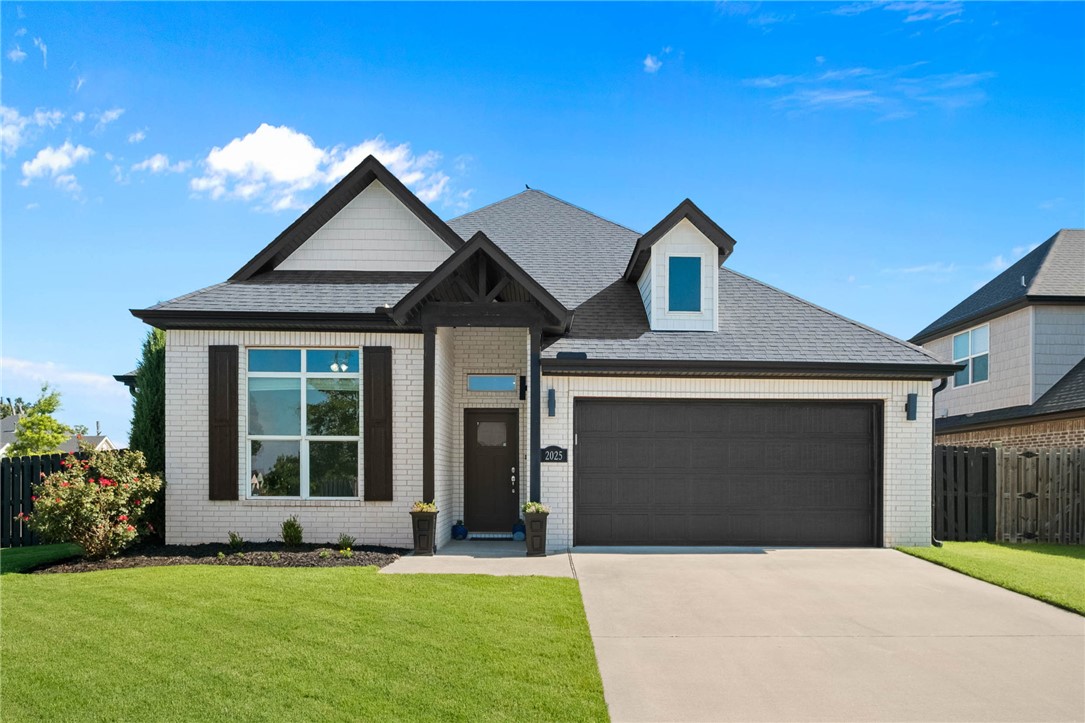 This corner lot home is perfectly located to all things NWA. Near Pleasant Grove, you are minutes from I-49, bike trails, the AMP, JB Hunt, Walmart, shopping, dining, entertainment and more! Exceptional curb appeal, landscaping, and turnkey condition welcome you. Solid-surface flooring runs throughout. A wall of picture windows showcases the park-like backyard and fills the open-concept living areas with natural light. The kitchen features quartz countertops, gas range, breakfast bar, and a well-designed pantry. The dining area offers the perfect seating arrangement that conveys. The family room is anchored by a statement fireplace and oversized windows. The primary suite boasts nearly 15' ceilings accented by beams, dual vanities, built-in closet organization, and a relaxation tub. Secondary bedrooms offer spacious closets, while the front bedroom's 11' ceiling creates an ideal office or bedroom. The luxury backyard boasts a large patio, designer landscaping, garden space, and plenty of green lawn. Welcome home!