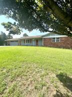 You will love the PEACE & TRANQUILITY this 2028 sq. ft. two story home offers! Entering Upstairs you will find a wood burning fireplace to enjoy, Granite Counters in the kitchen, two large bedrooms, two full bathrooms, & a true double garage. Downstairs there is a family room with a wet bar, a third bedroom, a full bathroom, & a LARGE laundry room. Just to name a few EXTRA FEATURES of the home: there's two covered outdoor living spaces, HVAC systems are under five yrs old, & NEW hot water heaters. ALL of this is situated 1.48 acres in a convenient and friendly neighborhood, which is CLOSE to all our community has to offer & QUICK interstate access. Book your personal tour today!