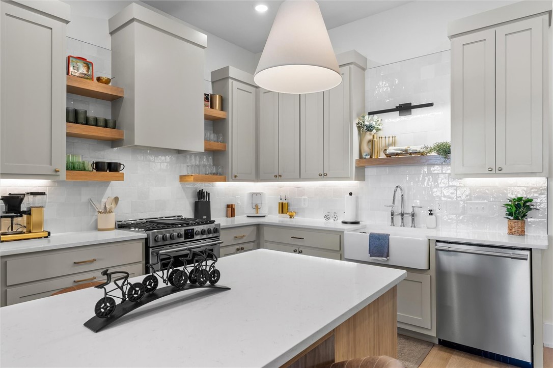 If you want to be able to walk to dinner, a movie, shops or ride trails this townhome is close to it all yet private and quiet. This large townhome is almost 2,500sf with great entertainment space including 3 separate patios, open kitchen with beautiful tile backsplash and open shelves, great guest rooms on the 2nd floor with attached bathrooms. Owner has entire 3rd floor as primary suite, and it does not disappoint with the oversized bedroom with sitting area, large private roof top deck and huge bathroom with walk in shower. The local art, wallpaper in powder bath and new light fixtures really makes this townhome stand out. Garage is large enough for 2 cars or a car and plenty of toys. Come see why this townhome is the perfect space to enjoy downtown Bentonville. Easy to maintain and lock up and leave as well. This townhome is a must see if your wanting to live the luxury life in downtown Bentonville.