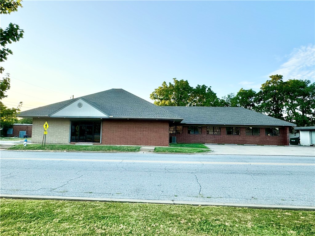 This Downtown Springdale 4469 sq.ft. commercial building with new paint and some new flooring has a variety of space options which would be great for an established, new or growing business. The layout includes a lobby, receptionist area, 15 individual offices, 2 large flex spaces, a break room, storage, mechanical space and 4 bathrooms. Past building use was a medical clinic. Continued clinic space would work well, or the building could also work for an education facility, tutoring center, a non-profit, childcare, art & music space, offices and much more. Located just off of historic Emma Ave, the property is in downtown's Outdoor Dining District and Art's District, and is in close proximity to the Razorback Greenway, Northwest Medical Center, schools, restaurants and more. There is on-site parking, street parking, and a free public lot across the road. Be a part of the growing excitement in Downtown Springdale.