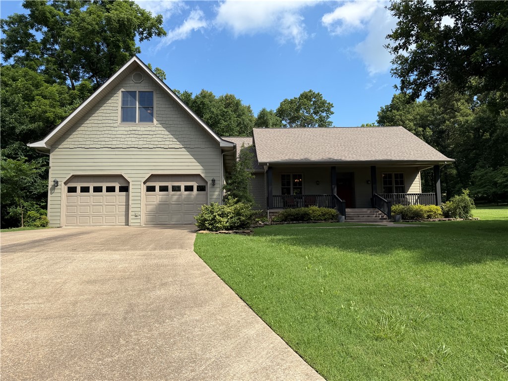 Tucked at the end of a quiet cul-de-sac, this beautifully maintained four-bedroom, three-bath home delivers the peaceful feel of country living without sacrificing convenience. From the welcoming front porch to the serene back patio, every detail has been thoughtfully designed for comfortable, low-maintenance living. Inside, rich hardwood floors anchor a spacious living room with soaring ceilings and a classic fireplace —the kind of space that feels equally at home for quiet evenings and lively gatherings. The kitchen impresses with granite countertops and generous room to cook and entertain. Bedrooms are well-proportioned throughout, and a versatile bonus room upstairs works perfectly as a playroom, home office, or hobby space. The fourth bedroom and third full bath are also privately situated on the upper level, ideal for guests or a teen suite. Step outside and discover an expertly landscaped backyard that opens onto a blend of wooded tree line and open pasture! Move in ready!