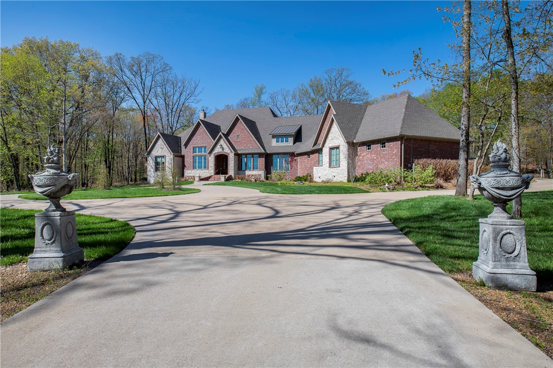 Back on the market due to the buyer's financing. This 8.16 acres with custom home boasts 4221 sq. ft. 3.5 bath, oversized 3 car garage with a E-Car charging station. The open concept designed for ease of living and socializing. The kitchen is appointed with granite, custom cabinets and Stainless Gallery appliances. A a center island, huge walk-in pantry, trash compactor, built-in ice maker and butler's pantry. Front guest bedroom with en-suite bath plus two additional bedrooms all with walk-in closets and share adjoining bathroom. The grand living room with stone FP, 18'ceilings , exposed beams, spectacular views and designer finishes ensure your family and friends will relax in style. The spacious master bedroom with exposed brick wall, exercise area, boutique closet and gorgeous en-suite bath with walk-in shower, soaking tub and two marble vanities. This home offers extra storage, large enclosed porch with 22' ceilings. Fenced and landscaped. Furnishings negotiable. Quick 15 min drive to Fayetteville Square.