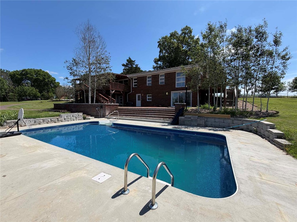 Looking for a home with acreage? This spacious 4-bedroom home with a full walkout basement sits on 15.55 beautiful acres in Bellefonte, Arkansas, offering Highway 206 frontage and plenty of room to enjoy the country lifestyle. The home features an attached 2-car garage, generous living space, and two decks overlooking the in-ground swimming pool. 
Outside, the property is well-equipped for a hobby farm, horse property, or anyone seeking room to spread out. The mostly open acreage is fenced and cross-fenced and includes a pond, well, fenced garden area, fruit trees, barn, shop, three horse stalls, chicken coop, and multiple outbuildings. Additional garage space provides ample room for equipment, vehicles, storage, or workshop use. Whether you're raising animals, growing your own food, or simply looking for a peaceful retreat, this exceptional Bellefonte property offers the ideal combination of usable land, practical improvements, and comfortable living in a convenient location.