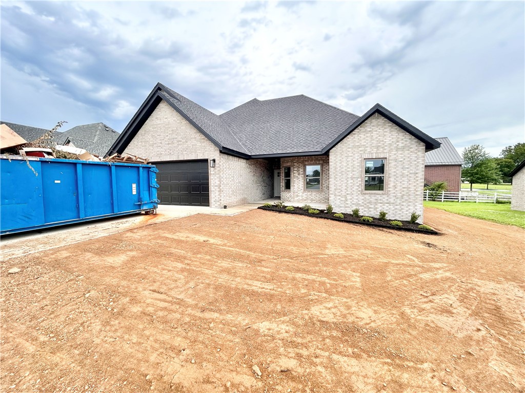 TO BE BUILT. Perfect time for you to pick out finishes! Discover the "Cambridge" plan, ideally situated close to the Pea Ridge High School and trails! Just 15 minutes from the new Walmart Campus! This beautiful home features 4 spacious bedrooms / 2.5 baths and a split floor plan. Enjoy the flexibility of a 3-car garage and the elegance of custom cabinets throughout. The kitchen includes a gas range and a huge island perfect for gatherings. Step out to the covered patio for outdoor relaxation and entertaining. $5,000 in buyer's closing costs from the builder's preferred lender. Schedule your showing today!