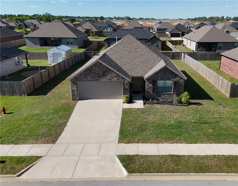 Beautifully maintained 3-bedroom, 2-bath home built in 2023 located in the desirable Wagon Wheel Crossing Subdivision! This modern home offers a functional split floor plan with an open-concept layout perfect for everyday living and entertaining. Luxury Vinyl Plank wood flooring flows throughout the living room, entry, kitchen, breakfast nook, dining area, and spacious primary suite. The kitchen features granite countertops, stainless steel appliances, abundant cabinet space, and seamless flow into the main living area. Enjoy energy efficiency with Low-E windows and relax year-round on the covered back porch overlooking the backyard. Additional features include a 2-car garage, modern finishes throughout, and a convenient location close to schools, shopping, dining, and easy access to Fayetteville and all Northwest Arkansas has to offer. Move-in ready and waiting for its next owner!