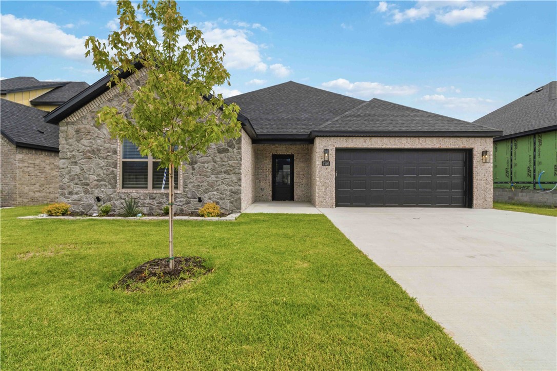 Modern Luxury Meets Timeless Design! Step into this stunning new construction home featuring an open-concept layout with designer finishes throughout. The show-stopping floor-to-ceiling stone fireplace creates a dramatic focal point in the spacious living area, complemented by custom built-ins and floating shelves. The gourmet kitchen offers sleek dark cabinetry, beautiful countertops, a large island, gas range, and stylish lighting that seamlessly flows into the dining and living spaces. Retreat to the luxurious primary suite featuring a spa-inspired bathroom with a freestanding soaking tub, oversized custom tiled shower, dual vanities, and an impressive walk-in closet with built-in storage. Enjoy outdoor living year-round on the covered back patio overlooking the backyard. With its modern finishes, thoughtful design, and exceptional craftsmanship, this home offers the perfect blend of comfort, style, and functionality.