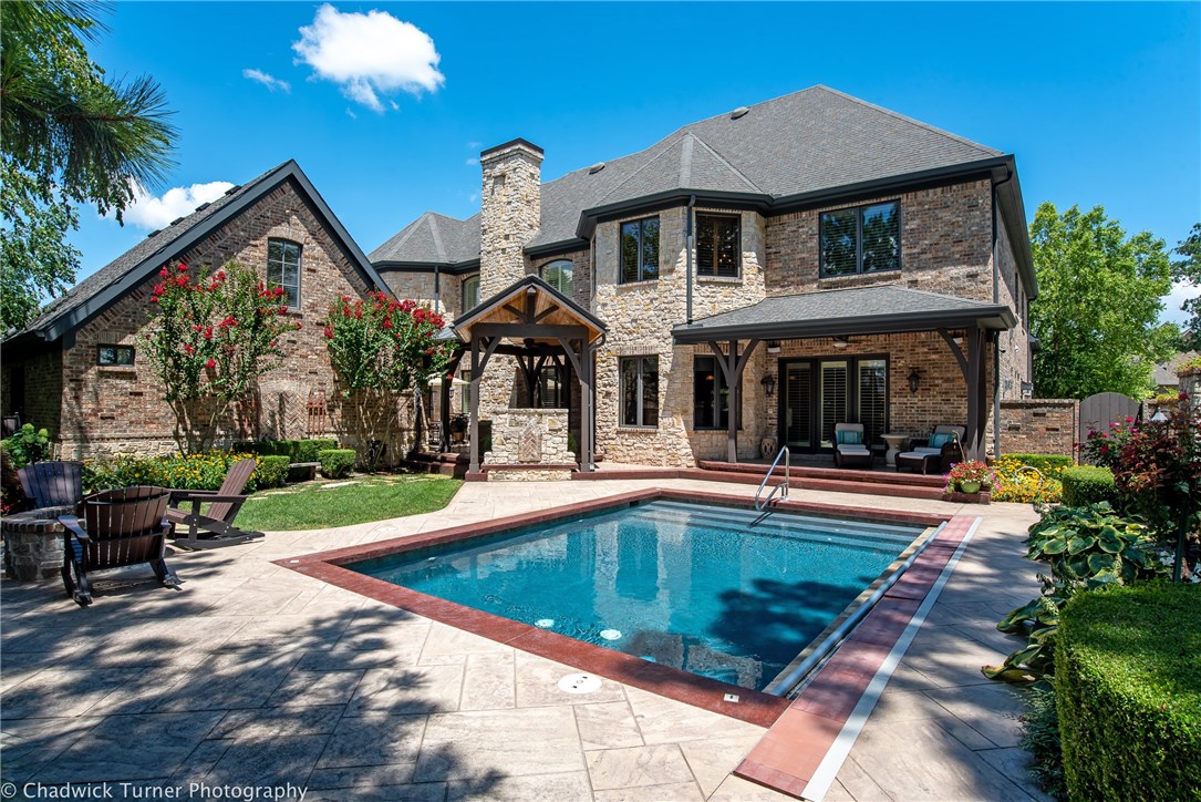 Custom, extensively detailed home in Pinnacle located in a private cul-de-sac. 100% stone & brick
detailing, featured landscape design, pointed "Gothic" arches highlighted throughout! Oversized rooms, 3 living areas, Bonus with wet bar, media, elevator,executive study, extensive built-ins with custom hand finishes, coffee bar, hidden "Narnia Room", incredible kitchen! 5 oversized garage bays-2 are heated/cooled w/ bonus&bath. Private in-ground pool with treetop views, outdoor fireplace & built-in grill!