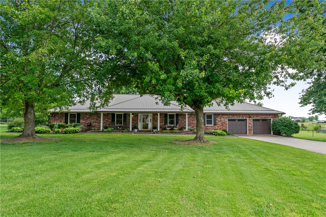 Experience the ideal blend of comfort, room to spread out, and country charm with this stunning 4-bedroom, 3.5-bath home situated on 6.92 beautiful acres in Springdale. Inside, you’ll find a spacious living area with vaulted ceilings that flows seamlessly into the dining area and kitchen, creating an inviting atmosphere for everyday living and entertaining, along with a flexible space ideal for a home office, reading nook or sitting area. The primary suite provides a relaxing retreat with an en-suite bath, generous walk-in closet, and backyard access, while the secondary rooms are generously sized and each include walk-in closets. Step outside and enjoy the serene setting with a hot tub, perfect for unwinding or entertaining. The property includes a barn with skylights, horse stalls, and a separate storage area, while the garage offers additional space. With ample acreage and a well-designed layout, it offers endless possibilities for rural living just minutes from town amenities
