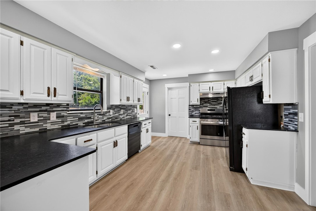 Completely remodeled and move-in ready! This beautiful 1,420 sq. ft. home features 3 bedrooms and 2 full baths with quality updates throughout all dome in 2025-2026.   Enjoy durable luxury vinyl plank flooring, stunning countertops, and a bright, modern interior designed for everyday living.. Major improvements completed in 2025 include a new roof and new HVAC system, offering peace of mind for years to come. Fresh landscaping enhances the curb appeal, creating a warm welcome from the moment you arrive. Conveniently located in Springdale, this turnkey home is ready for its new owners. Schedule your private showing today!