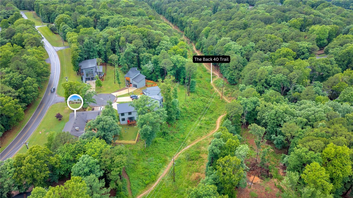 Beautifully updated home in Bella Vista situated on a desirable corner lot with direct access to the scenic Back 40 Trail and located just minutes from Lake Ann, Lake Rayburn, and the OZ Bike Lift! Enjoy the perfect blend of outdoor adventure and peaceful living with a private backyard setting and fresh updates throughout. Recent 2025 upgrades include a new back deck, privacy fence, and a new HVAC system, plus a beautifully renovated primary bathroom featuring a spacious walk-in shower. The bonus room above the garage offers flexible space for a home office, movie room, playroom, or second living area. Ideal for biking enthusiasts, nature lovers, or anyone looking to enjoy all that Bella Vista living has to offer!