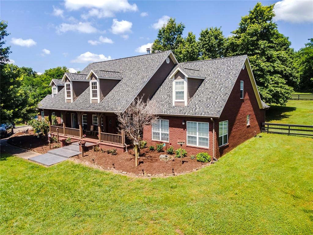 Prepare to be amazed by this beautiful 7-bed, 5-3/4 bath, 4385 sq. ft. estate situated on 13.5+/- acres in Cane Hill, AR located off of paved CR 13. Property boasts a stocked pond, spacious yard with recently updated backyard fencing, paved asphalt driveway, and abundant mature trees on the property with views of historic Cane Hill. This well-built, 1-owner brick home showcases 2 living areas with double wood-burning fireplace and LVP flooring throughout. The recently updated kitchen showcases granite counter tops and stone backsplash. The many extras included with this home include an updated roof with class 4 architectural shingles, updated light fixtures/recessed lighting, additional 20x32 ft stand alone, 2 car garage; 4 stall pole barn with loft and Galvalume panels, covered front porch, large back patios ideal for entertaining, wood shed, spacious garden spot, and abundant wildlife. This rare and immaculate home and property are a MUST-SEE for anybody searching for a piece of paradise in NWA!