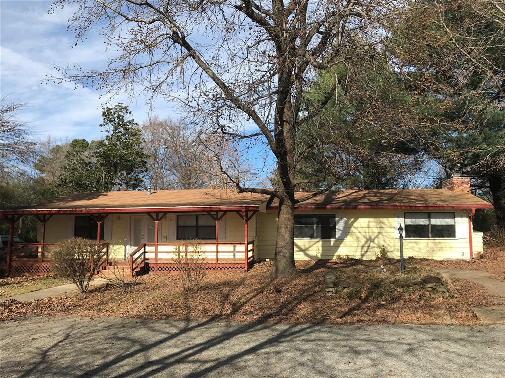 Four bedroom, three bath home with two living areas. 24' x 24' detached workshop with concrete floor & electric, 12' x 32' carport. Private cul de sac street, large secluded .41 acre lot in desirable location - near downtown Rogers. Hardwood, carpet & ceramic hardwood floors. Redwood exterior siding, fenced backyard. Wood-burning fireplace in second living area. 2015 remodel - added bath in bedroom, new water heater, new gutters, new chimney cap & brick seal, new walls & floors in newer addition. 2018 new HVAC - under warranty - Bud Anderson. 2019 new dishwasher, new front door, interior paint & major tree removal. Refrigerator, washer & dryer convey.