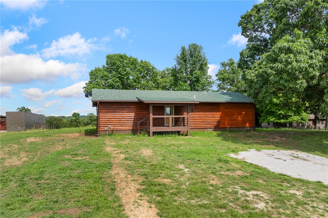 There’s just something about a log home that feels different the moment you walk in, and this one is no exception. From the warm wood interior and vaulted ceilings to the natural gas fireplace and peaceful setting, this home has a comfortable, welcoming feel that’s hard to find.
Situated on over an acre in Harrison, this 3 bedroom, 2 bath home offers a great balance of rustic charm and modern updates. The open living area flows into a custom kitchen featuring granite countertops, unique western-inspired cabinetry, and a one-of-a-kind island that gives the space a lot of personality.  A new HVAC system has also recently been installed, giving the next owner added peace of mind.
Outside, you’ll appreciate the mature shade trees, usable yard, and country atmosphere while still being just a short drive from town. Whether you’re looking for a place to slow down a little, enjoy quieter surroundings, or simply own a home with character, this property is worth a look.