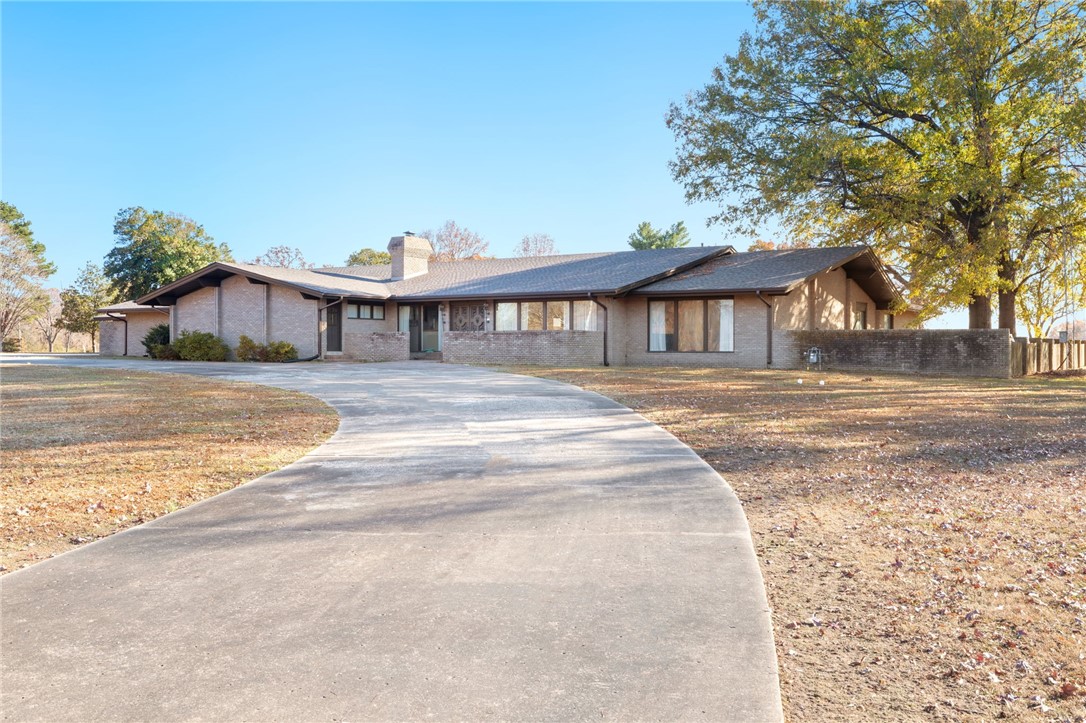 A home fit for entertaining with over 7,500sqft of interior space, large kitchen with island & tons of cabinet space, 2 living rooms, large laundry room, and an exceptional amount of natural light pouring in through the multitude of floor to ceiling windows! Throughout, you will find custom tile work & sinks, vintage wall decor, inviting oversized wet-bar, & stunning shiplap vaulted ceiling. Each bedroom offers a private ensuite and private patio. Enjoy outdoor living with expansive covered patio, private 80,000 gallon pool with diving board, &  1,200 sqft pool house complete with 2 bedrooms & one full bathroom. 30x60 shop building, with 2 10 foot automatic doors also offers approx. 500sqft of decked loft/mezzanine space. Roof and gutters were replaced in 2020. Agent is related to seller.