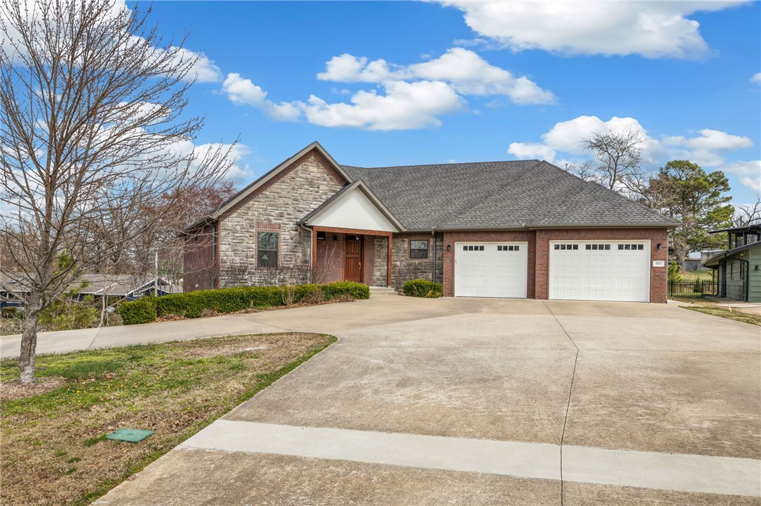 Rare in every sense. A true half-acre in the heart of Downtown Bentonville, with a trailhead at the driveway and Park Springs Park bordering the property to the north — this is the kind of property that simply doesn't come available.  The 4,106sqft residence offers 5 bedrooms and 5.5 baths across a thoughtfully renovated floor plan — new lighting, plumbing fixtures, and quartz countertops throughout, and a dedicated storm shelter. A fully private 532sqft 1 bed / 1 bath garage suite with its own exterior entrance, separate from the 3,574 square foot main house — ideal as a family guesthouse, private office, or income-generating rental.  Step outside to two covered patios, a private hot tub, and a beautifully scaled backyard on a lot that is genuinely rare for this zone. An oversized two-car garage and circle drive complete a property without comparison in Downtown Bentonville.