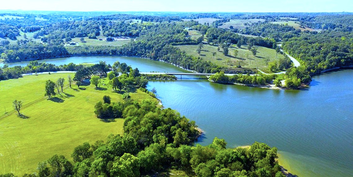 10-acre Lakefront Estate where nothing stands between you and the water. Enjoy the best of Table Rock Lake with panoramic views and a gentle walk-down to the water’s edge of your private shoreline. Such easy access for fishing, swimming, or launching a kayak is a level of convenience that transforms how you experience life on the lake.
3BR/2BA waterfront residence alongside a timeless 1900s Barn. 
40x50 Metal Shop/Garage provides secure storage for boats, trailers, and lake equipment. 
10 usable acres provide ample room for cattle, sheep, horses, or additional build-sites.
Rural water and electric on-site.
727 ft +/- of gentle “walk-to-water" Table Rock Lake private shoreline. 
1,000 ft +/- Highway 311 frontage.
Tucked away in a peaceful pocket of the lake, your immediate surroundings offer total privacy while being situated in the high-growth Northwest Arkansas corridor and Branson tourism epicenter.
Expand your shoreline and highway frontage—Additional Acreage Available!