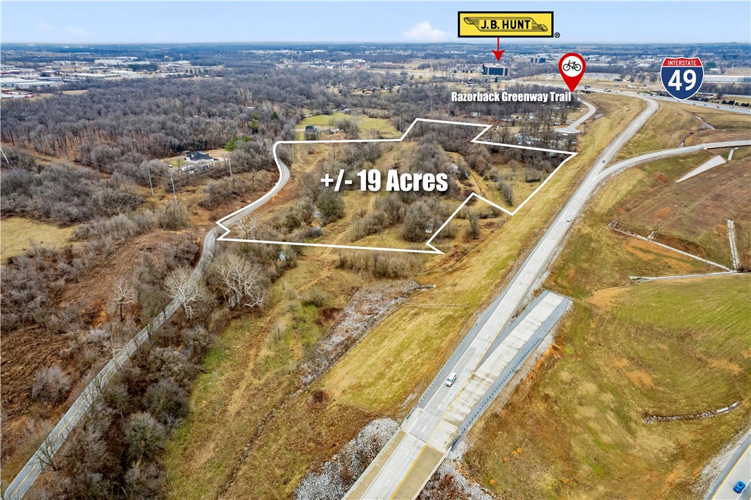 Potential for multi-family development, this +/- 19 acre site has a sewer line running along the south side of Puppy Creek. Potential access into the site would need to come from the south off of Burrell Pl (No easements currently granted). Even though this property is in the heart of beautiful Northwest Arkansas, close to all amenities: less than 5 minutes to JB Hunt Corporate World HQ, less than ten minutes to Pinnacle Hills Promenade Mall, restaurants, shopping, I-49 freeway, 11 minutes to XNA airport, less than 5 minutes to the new 612, this property has a wooded feel and a beautiful creek. Puppy Creek might work for detention purposes but needs to be explored by prospective buyers, as does feasibility of all of the aforementioned. Currently Zoned R-2 Intermediate Neighborhood. It is a Springdale Sewer Line but Lowell Administers it. Buyer would also need a well, but water is on the property to the south.