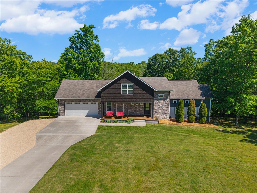 Some homes check boxes. This one raises the bar. This stunning 4-bed, 4-bath, 4,491sqft home sits on 3 private acres in Bentonville, and it's loaded with high-end finishes throughout. The open, light-filled layout is built for real living, with a kitchen that delivers on both style and function. A second living room and a game room with a wet bar make this home an entertainer's dream from the moment you walk in. The spacious primary suite offers the retreat you've been looking for, and three additional bedrooms plus an office gives everyone room to spread out. Enjoy views from the top deck or from the downstairs walkout patio, your own private oasis. But the real showstopper? A massive shop with a dedicated woodworking station and enough room to add a full gym, the kind of space most people spend years wishing they had. In the backyard you'll also find the treehouse of your kid's dreams. Three acres of privacy, zero compromise on location. This is Bentonville living at its best.