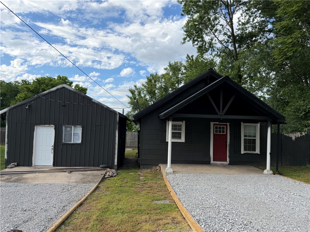 Charming investment opportunity in the heart of Siloam Springs. This unique property features a 2 Bed 1 Bath home with a detached approximately 400 square foot shop building that has already begun conversion into a potential 1 Bed 1 Bath rental or guest space. Whether you are looking to expand your investment portfolio with two possible rental units or live in the main home while finishing out the additional space for income potential, this property offers endless possibilities. Main home includes a metal roof, central hvac, gas wall heater, keyless entry, blinds, Jack-and-Jill bathroom, covered front porch, privacy fence and fresh exterior paint. Refrigerator, washer and dryer all convey with the property. The shop conversion is a fixer-upper project that needs to be completed. Cabinets, shower and other materials are already in place. Anything currently there to help complete the project will stay. Don’t miss the opportunity to make this property your own investment adventure or live-and-rent setup!