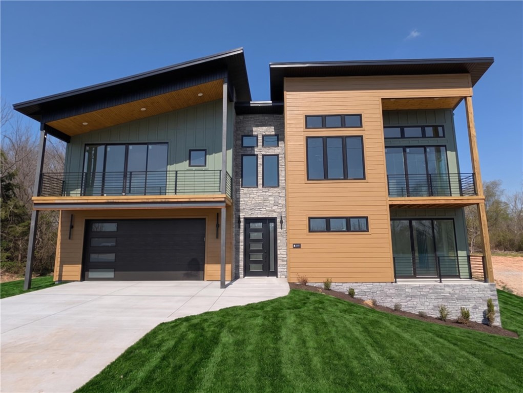 Welcome To Your Next Home! If Beige Boxes And Builder-Grade Boredom Make You Yawn, Buckle Up, Because This One Is A Whole Mood. Mountain Modern To Its Core, It Throws Sharp Rooflines, Warm Multitone Siding, And Stacked Stone Together Like It Was Born On A Magazine Cover. Step In On The Lower Level, Then Head Up Where The Home Really Shows Off. Tongue-And-Groove Vaulted Ceilings Glow Over A Wide-Open Living Space, And The Star Of The Show Is A Floor-To-Ceiling Stone Fireplace Practically Daring You To Pour A Drink And Stay Awhile. Sunlight Pours Through Walls Of Windows From Every Angle. The Kitchen Flexes Hard With An Oversized Island, Brooding Custom Cabinetry, A Fluted Statement Hood, And Granite For Days. Bathrooms Channel Boutique-Hotel Drama Through Inky Vertical Tile And Frameless Glass, While The Built-In Mudroom Keeps Real Life Sharp. Triple Covered Balconies And Porch Areas And A Spacious Deck Give You Multiple Spaces To Soak Up Every Season. This Is Not A House You Scroll Past. Come See!