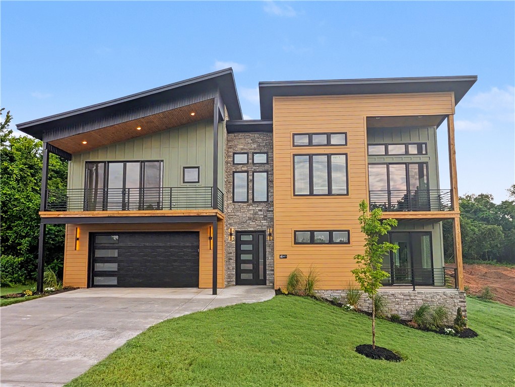 Welcome To Your Next Home! If Beige Boxes And Builder-Grade Boredom Make You Yawn, Buckle Up, Because This One Is A Whole Mood. Mountain Modern To Its Core, It Throws Sharp Rooflines, Warm Multitone Siding, And Stacked Stone Together Like It Was Born On A Magazine Cover. Step In On The Lower Level, Then Head Up Where The Home Really Shows Off. Tongue-And-Groove Vaulted Ceilings Glow Over A Wide-Open Living Space, And The Star Of The Show Is A Floor-To-Ceiling Stone Fireplace Practically Daring You To Pour A Drink And Stay Awhile. Sunlight Pours Through Walls Of Windows From Every Angle. The Kitchen Flexes Hard With An Oversized Island, Brooding Custom Cabinetry, A Fluted Statement Hood, And Granite For Days. Bathrooms Channel Boutique-Hotel Drama Through Inky Vertical Tile And Frameless Glass, While The Built-In Mudroom Keeps Real Life Sharp. Triple Covered Balconies And Porch Areas And A Spacious Deck Give You Multiple Spaces To Soak Up Every Season. This Is Not A House You Scroll Past. Come See!
