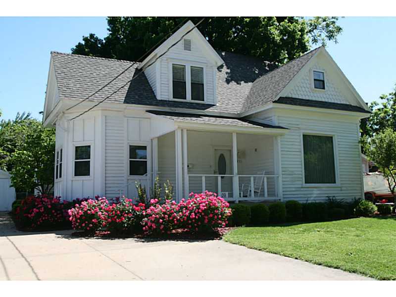 Adorable Historic home close to everything! Lots of rooms, character & possibilities. 2 covered porches, large workshop & storage building. Must see to truly appreciate!