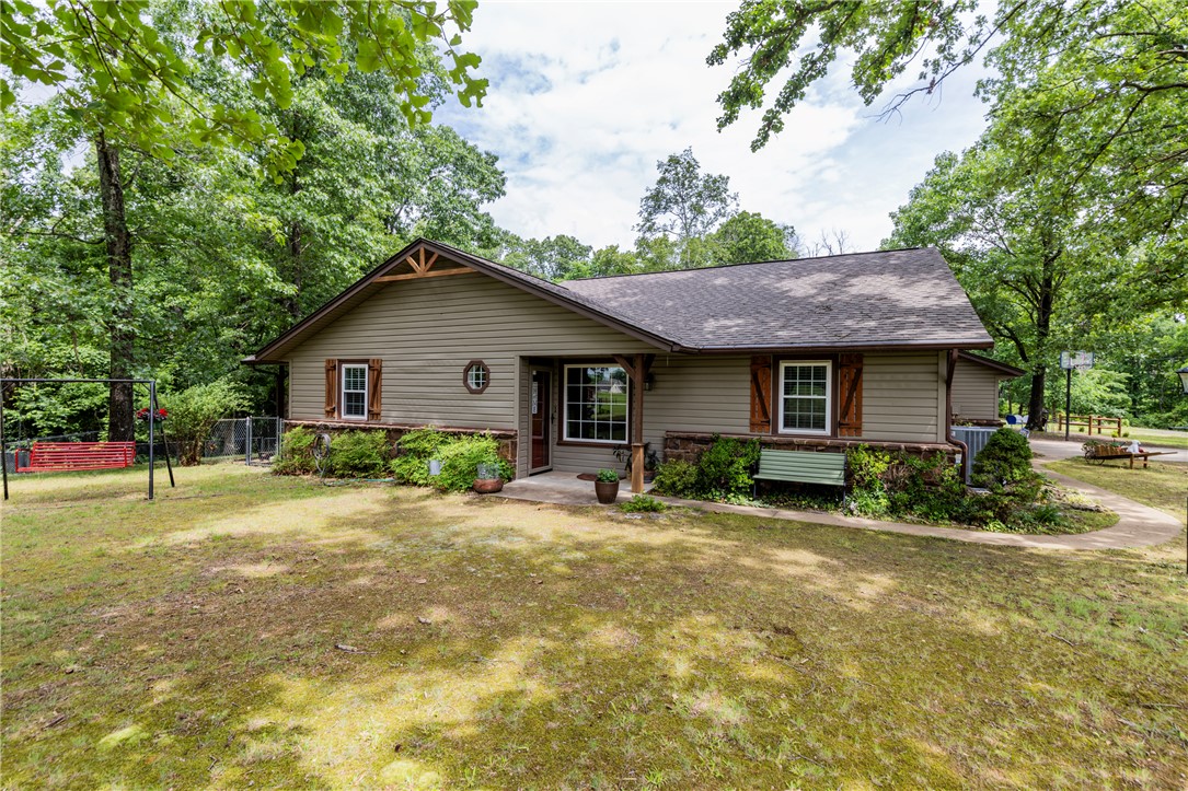 Bring your horses and enjoy peaceful country living on approximately 6 beautiful acres in Bentonville. This mini ranch offers the perfect combination of privacy, functionality, and convenience with a one-level home, impressive 30x40 shop, 12x20 storage building, horse barn, fenced areas, and open pasture space — all just minutes from town and nearby biking trails.

Inside, the home features a warm and inviting layout with vaulted ceilings, a cozy fireplace, spacious living areas, and a functional kitchen with abundant cabinetry and a peninsula for additional seating and prep space. Kitchen stove is induction & has a convection oven. The primary suite and baths offer spa-like touches including walk-in showers and relaxing finishes.

Outdoor living shines with a covered deck, covered patio, outdoor dining area, private hot tub, and scenic views in every direction. A rare opportunity to own acreage and versatile improvements in a highly desirable Bentonville location at Plentywood Farms! Welcome Home!