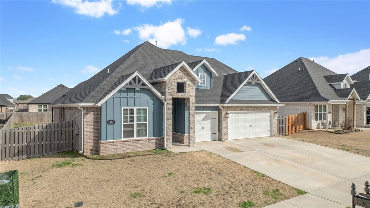 Welcome to this beautifully designed home located in the heart of Pea Ridge. Built in 2022, this home combines modern finishes with a functional layout that makes everyday living comfortable & stylish.

The main living area features soaring vaulted ceilings & an open layout perfect for entertaining! The kitchen has granite countertops, soft-close cabinetry, & generous prep space, flowing into the dining area with a charming shiplap accent wall. From here, step out to the covered patio & fenced backyard—ideal for relaxing.

The split floor plan creates a private primary retreat with a spacious ensuite featuring dual vanities, a soaking tub, & a large walk-in closet that connects to the utility room.

A second bedroom & full bath are located on the main level, while upstairs offers two additional bedrooms & a third full bathroom.

New carpet was installed in all bedrooms 02/2026. With a great layout & convenient access to Pea Ridge amenities—including the community pool—this home is ready for its next owners!