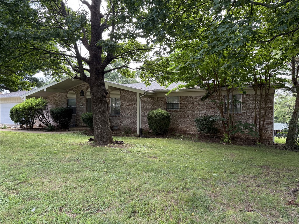 Spacious brick home situated on a double lot in an established Harrison neighborhood! Located at 607 Skyline Drive, this well-maintained home offers 3 bedrooms and 2 full baths on the main level, along with a formal living room, large den featuring a gas log fireplace, dining area, and an eat-in kitchen designed for everyday living and entertaining. The attached 2-car garage provides convenient main-level access. The walk-out basement adds exceptional living space with a large family room featuring a cozy wood-burning fireplace, an additional bedroom, full bath, and plenty of flexibility for guests, a home office, or multi-generational living. The oversized double lot offers extra outdoor space for gardening, recreation, or future possibilities. Conveniently located near schools, shopping, and medical facilities, this home combines comfort, space, and a desirable location.