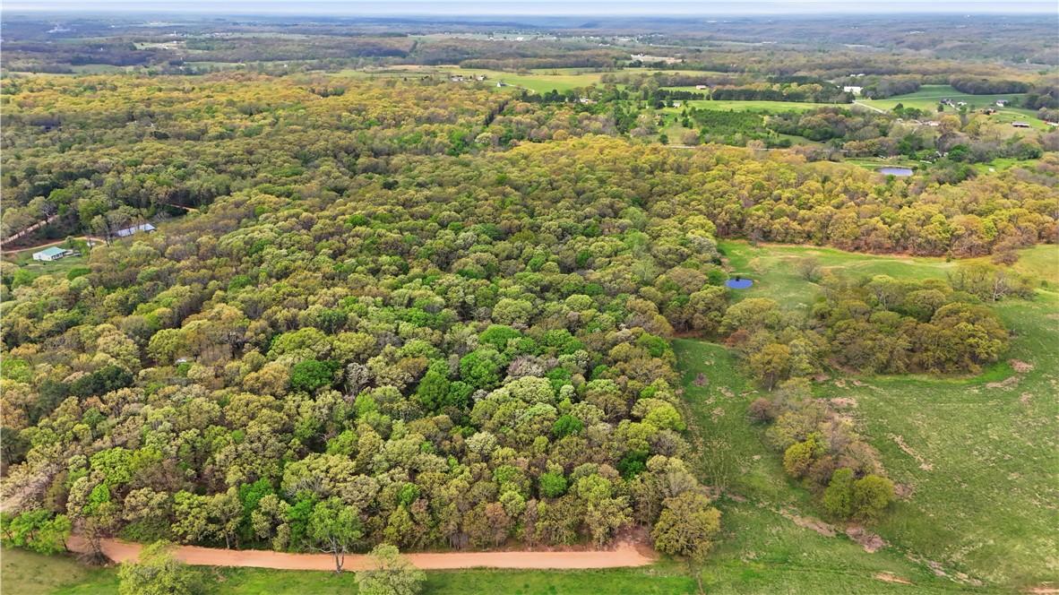 Discover the ideal location for your custom estate on this versatile acreage that perfectly balances seclusion with accessibility. Located just 10 minutes from I-49, 25 minutes from the Home Office, and 2 miles from the future site of the North-South Connector, this 2.13-acre property offers prime convenience. The land features a scenic mix of level and gently rolling terrain, providing numerous optimal build sites that are easy to navigate. A 5-bedroom perc test is already on file. Enjoy a private atmosphere while remaining minutes away from the amenities of  Gravette,  Centerton,  Bella Vista, and  Bentonville.