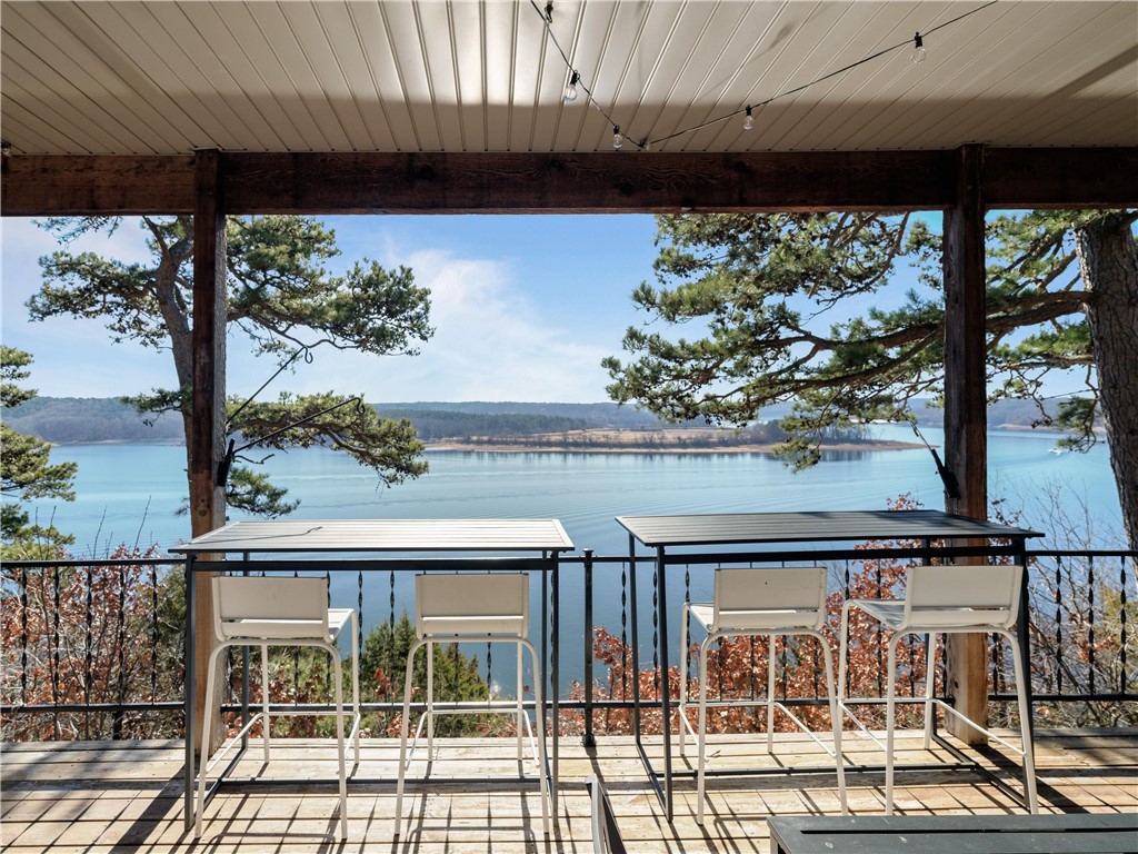 Lakefront Luxury Meets Investment Opportunity! Stunning Beaver Lake home sits privately at the end of a quiet cul-de-sac, offering incredible views of the lake. Designed with comfort and functionality in mind, the home features an open and spacious layout, 2 bedrooms & 3 bathrooms.  Step out onto the covered back deck — part of it screened — to take in the panoramic lake views. The lower level provides additional open living and sleeping space along with a full bath — ideal for guests or extended family. A 20x22 shop sits beneath the garage, offering great storage or hobby space. Included is a 2-slip (10’x26’) boat dock with an 8’x12’ swim deck, one slip featuring a boat lift, making lake days effortless. This home has been a highly successful short-term rental since December 2023, earning great reviews and staying consistently booked. Being sold fully furnished, offering a true turnkey opportunity for anyone looking to continue the vacation rental income or simply move right in and start living the lake life!