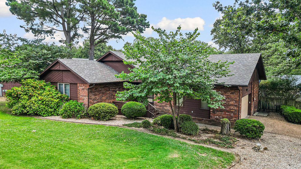 Discover the charm of this 3-Bedroom, 2-Bath home in the heart of Bella Vista, which is quickly becoming one of the nation's top destinations for outdoor enthusiasts.  Offering a blend of tasteful updates and opportunities to add your own finishing touches, this home is perfectly positioned on an oversized lot just steps from golfing and world-class trails, and just minutes from other Bella Vista amenities.
A spacious sunroom off the living area provides additional living space, making it the perfect spot to enjoy your morning coffee overlooking your oversized yard with mature trees, which is perfect for taking in the peaceful surroundings of beautiful Bella Vista.
One of the standout features is the efficient wood-burning stove, which is vented throughout for maximum energy efficiency in the cooler Arkansas months.  Outside, you will find a detached outbuilding perfect for storing all of your golf clubs, bikes and kayaks or for extra workshop space.