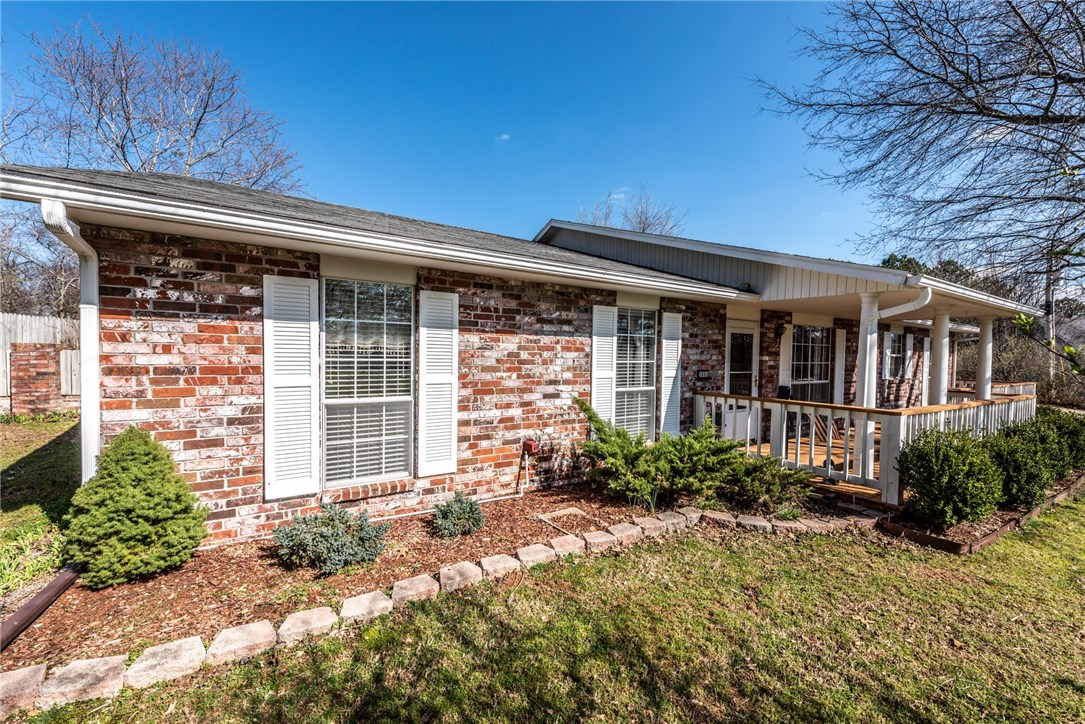 Home Sweet Home! 1.40 landscaped acres in the heart of Fayetteville featuring an all brick 3BD/2BA, spacious covered front porch, wood floors in LRoom & entry, combined wood burning & gas FP, Tiled eat-in kitchen w/ abundant creamy white cabinetry, SS appliances & attached Formal Dining, MBedroom w/ wood floors & full attached bath, Large Covered back porch overlooking beautiful tree studded acreage & Garden area! Additional detached 23x29 2 car garage/shop, 7x7 storage building, 18x12 wood room & more!