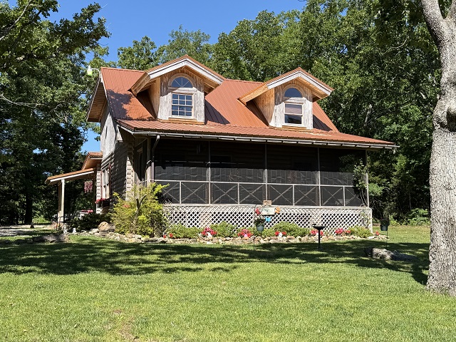 Discover the perfect blend of rustic charm and modern comfort in this beautifully crafted log home, nestled on 20 private acres m/l in the rolling hills of Sharp County. Hand-hewn log construction, gleaming bamboo hardwood floors, and a fully updated kitchen with newer stainless steel appliances create a warm, inviting interior. The main level features two spacious bedrooms and two full bathrooms with attractive tile flooring. A large loft with its own closet offers flexible use as a third bedroom, office, or creative space. The property is ideal for hobby farming or homesteading, with fencing, fruit trees, and multiple outbuildings ready for animals, equipment, or workshop needs. A new septic system, French drains, storm shelter and a striking bronze metal roof provide long-term peace of mind. Enjoy a mix of wooded acreage—perfect for hunting, hiking, and privacy—and open pastureland ready for livestock or expansion. This is true Ozark living: quiet, scenic, and full of possibility.