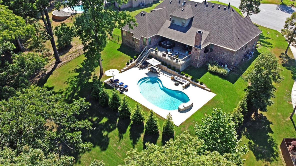 Exquisite Home w/Pool & Private Backyard in Prestigious Versailles Subdivision. Located in a Cul-de-Sac on an Acre Lot w/Mature Trees, 3 Side Entry Garages w/Extended Driveway, Covered Patio w/Fireplace + Hot Tub + Deck area overlooking Pool w/Lush Landscaping. Fantastic Floor Plan w/4 BDRMS on Main, Formal Dining, Wet Bar, Office w/French Doors, Spacious Living RM w/Fireplace & Coffered Ceiling. Gourmet Kitchen is Chef's dream, Large Island & Prep-sink, Double Oven, Granite Counter Tops & Large walk-in Pantry. Gorgeous Master on Main w/Sitting Area, Fireplace, Trey Ceiling & access to deck. Fabulous Master Bathroom w/Soaker Tub, Separate Vanities & Oversized Walk-in Shower w/3 Shower Heads. 3 other BDRMS on Main w/Jack & Jill + additional Full Bath. All Closets w/designer Built-in shelving.  Upstairs w/Media Room + Additional Bonus RM + Wet Bar + Guest Suite + Full Bath. Don’t miss your chance to own a Beautiful Capstone Home w/Lots of Great Features, Extensive Molding & attention to details. Welcome Home!!