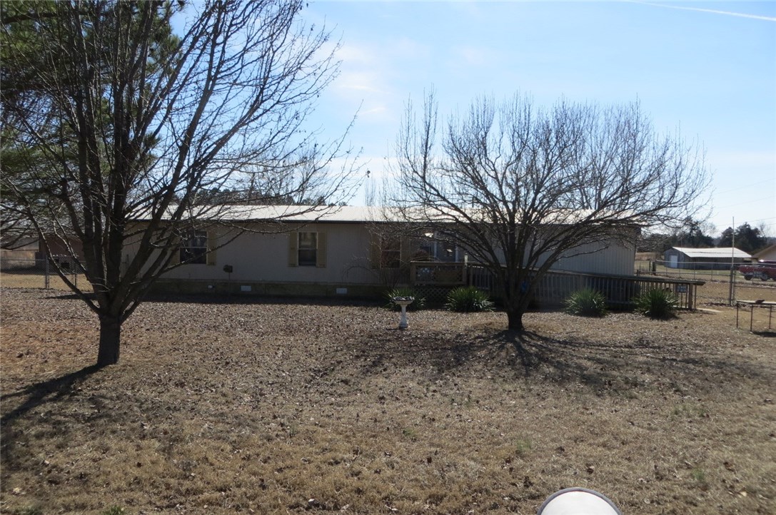 3 bedroom, 2 bath mobile home, being sold "as is" on almost 2 acres.  Fenced backyard with 2 outbuildings, and a metal roof over mobile home.