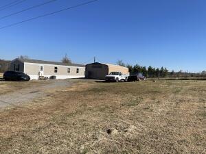 Looking to get out of town!! 2021 Victory Plus Mobile home that has 3 bedroom, 2 full baths. An addition there is a nice big insulated shop/garage that has an apartment in the back with a half bathroom. Brand new storm shelter and a nice big yard. Has a fence yard on the side for dogs. Driveway is off a paved road.
