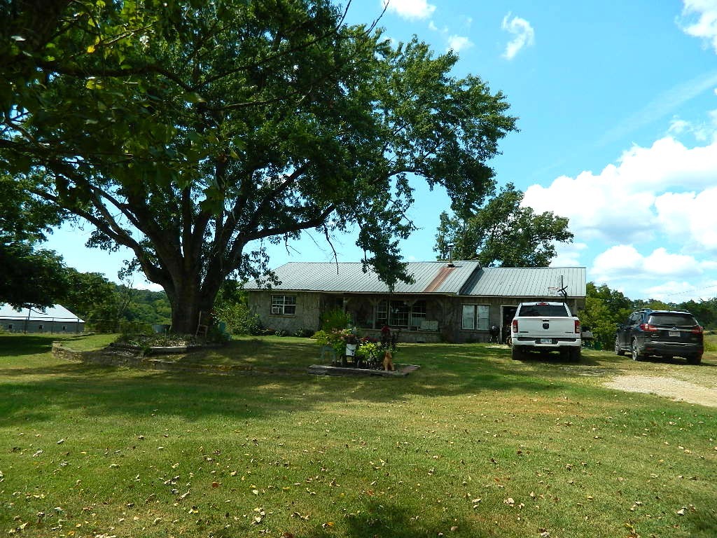 Come Home to Dry Fork Creek — Beautiful Country Living on 123 Acres! Welcome to your dream homestead along the serene, year-round spring-fed Dry Fork Creek. This stunning 123-Acre property offers peaceful privacy just minutes from Hwy 412 — the perfect mix of seclusion and convenience. 
With 90% pasture, the land is ideal for livestock or hay, producing approx. 220 round bales per cutting. The adorable farmhouse is cute as a button, with cozy living spaces, and charm throughout. Two water wells, both of which have never been dry, ensure reliable water. Features include: Two 43x500 poultry houses (active until 2025); Two barns, a shop, and a working cattle pen; Fertile pastures and natural beauty throughout; A clear swimming hole on the spring-fed creek for relaxing or play.
If you're seeking productive land, privacy, and rural beauty — Dry Fork Creek is calling you home! Agent Related to Seller - Also, see MLS# 1318153