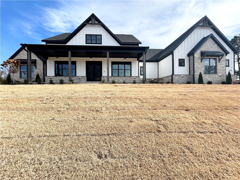 New construction estate in Healing Springs! This stunning home sits on a flat 1-acre lot, offering serene wooded views and privacy. Featuring a large 3-car garage with epoxy floors, this residence boasts 5 bedrooms plus a formal dining and bonus room. Natural light floods the open living and kitchen areas, creating an inviting atmosphere for gatherings or relaxation. The kitchen is a chef's dream, featuring floor-to-ceiling cabinets, double oven, 36'' 6 burner gas cooktop, built-in refrigerator, and an oversized pantry. The primary suite includes a fireplace, wood ceiling & beams, double vanity, soaking tub, and an oversized walk-in custom shower. Enjoy entertaining on the huge covered patio, complete with a ½ bath, fireplace, grill, and fridge—ideal for outdoor gatherings. Plenty of space for an in-ground pool!  Custom finishes and built-ins throughout! Bentonville schools. Schedule your showing today.